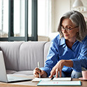 Woman working and writing at table