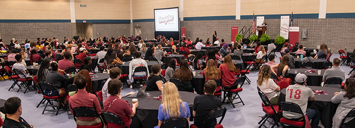 a large group of students sit together at conference tables at Imagine Carolina