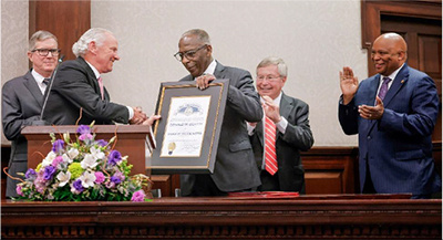 Chief Justice Beatty receiving the Order of the Palmetto from Governor McMaster.