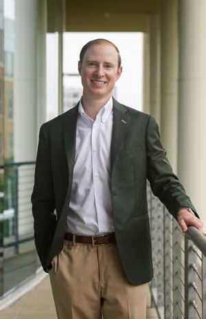 Drew Stevens standing on terrace at the Moore School