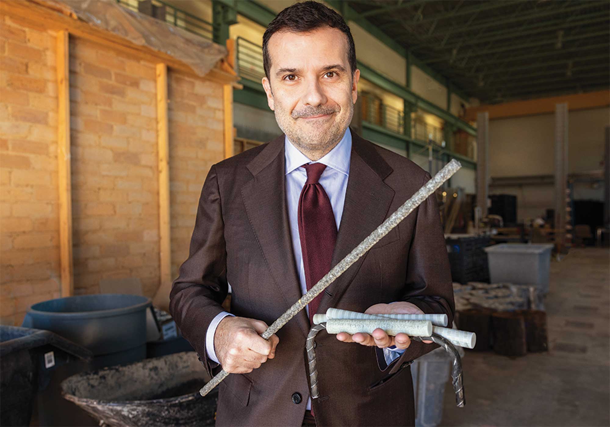 Fabio Matta smiles for the camera as he holds his next-generation building materials
