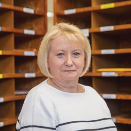 portrait of Sarah Kelly in the mail room