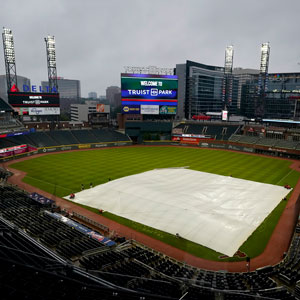 baseball diamond in Truist Park in Atlanta with rain tarp in place and view of skyline in background