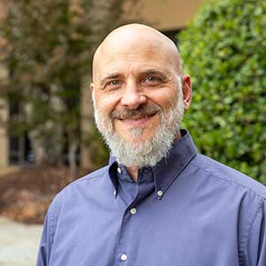 Kevin Bennett smiles outside the School of Medicine Columbia