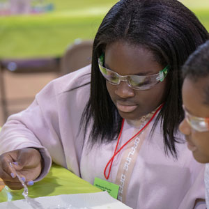 Students wear protective glasses while learning at camp