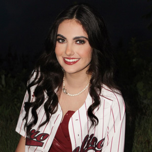 A girl smiles at the camera.