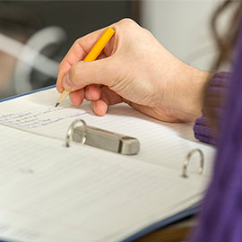 A student taking notes in class.