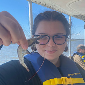 Alexis Yum holding a shrimp at Baruch Institute Alexis Yum holding a shrimp at Baruch Institute
